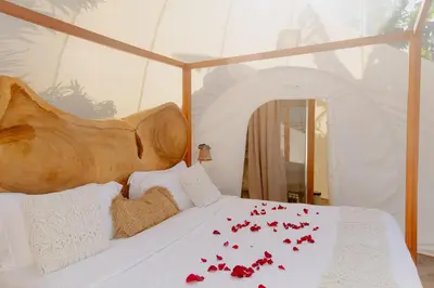a bedroom with a bed with red roses on it at Green Land Bubble Glamping in Cabarete