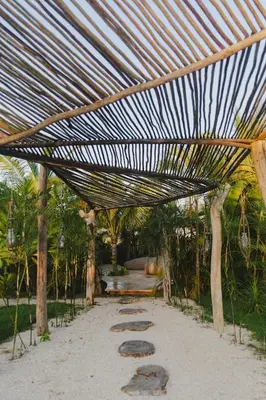 acovered area with footprints in the sand in a garden at Green Land Bubble Glamping in Cabarete