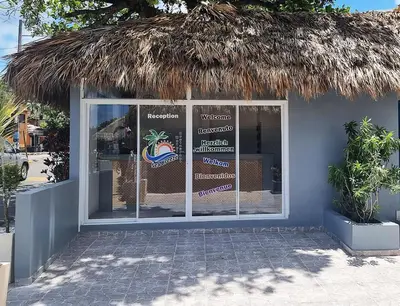 a store front with a straw roof at Hotel Sea Breeze Sosua in Sosúa