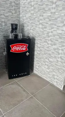 a soda machine with a coca cola sign on a wall at Hotel Sea Breeze Sosua in Sosúa
