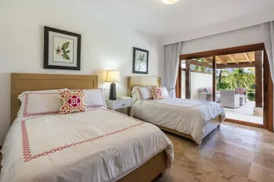 a bedroom with two beds and a balcony at The Greatest 3BR Villa at Puerto Bahia in Los Grini