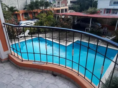 a balcony with a swimming pool with a railing at Apartahotel Next Nivel - One bedroom apartment in Punta Cana