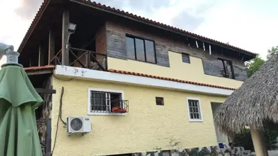a building with a window and a roof at VILLA CAMPESTRE EN LOMAS LINDA in Villa Altagracia