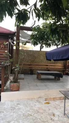 a patio with a bench and a table at VILLA CAMPESTRE EN LOMAS LINDA in Villa Altagracia