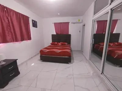 a bedroom with two beds and a mirror at Apartamento amueblado en Santiago, Res Blue Amber, 2 habitaciones in Santiago de los Caballeros