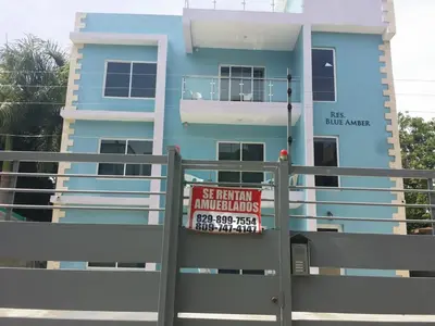 a blue building with a sign in front of it at Apartamento amueblado en Santiago, Res Blue Amber, 2 habitaciones in Santiago de los Caballeros
