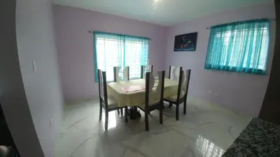 a dining room with a table and chairs at Apartamento amueblado en Santiago, Res Blue Amber, 2 habitaciones in Santiago de los Caballeros