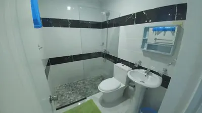 a bathroom with a toilet and a sink at Apartamento amueblado en Santiago, Res Blue Amber, 2 habitaciones in Santiago de los Caballeros