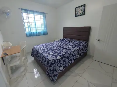 a bedroom with a bed and a table and a window at Apartamento amueblado en Santiago, Res Blue Amber, 2 habitaciones in Santiago de los Caballeros