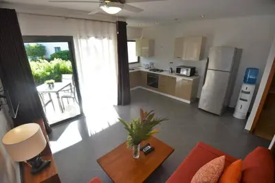 a kitchen and living room with a couch and a table at Oasis Apartment C4 inside ALIGIO Residence Hotel in Las Terrenas