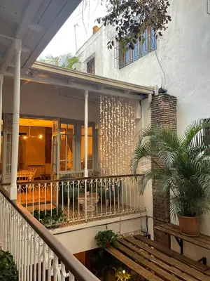 a porch of a house with a staircase at Mosquito Boutique Hotel Zona Colonial in Santo Domingo