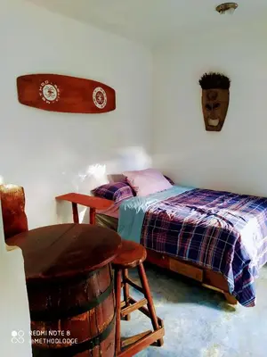 a bedroom with a bed and a table and a chair at Method Living Tropical Edition 50024 in Cabarete
