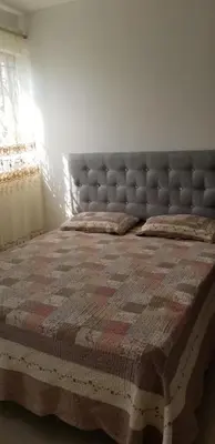 a bedroom with a bed with a quilt on it at Cerro Altos jardin 809-488-8618 in Santiago de los Caballeros