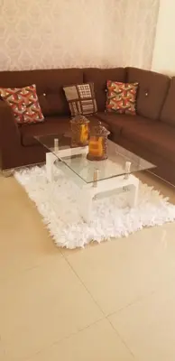 a living room with a couch and a glass coffee table at Cerro Altos jardin 809-488-8618 in Santiago de los Caballeros