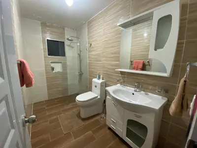 a bathroom with a toilet and a sink and a mirror at 6A Cozy Apt in Santiago Center - Great Stay in Santiago de los Caballeros