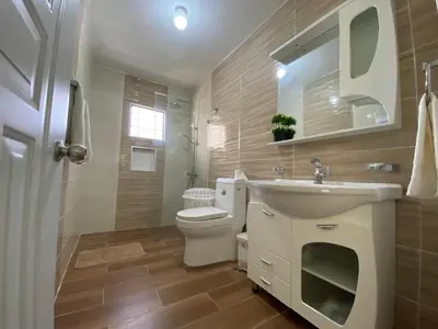 a bathroom with a sink and a toilet and a mirror at 6A Cozy Apt in Santiago Center - Great Stay in Santiago de los Caballeros