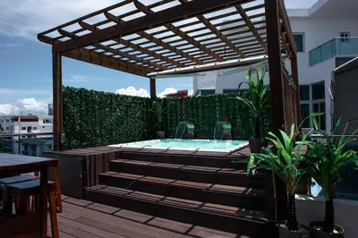 a hot tub on a patio with a pergola at Santo Domingo Luxury Apartment with 8 Bedrooms in Santo Domingo