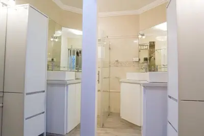 a bathroom with two sinks and two mirrors at Santo Domingo Luxury Apartment with 8 Bedrooms in Santo Domingo