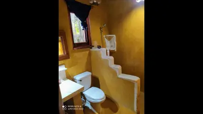 a bathroom with a toilet and a sink and stairs at Method Living Tropical Edition in Cabarete