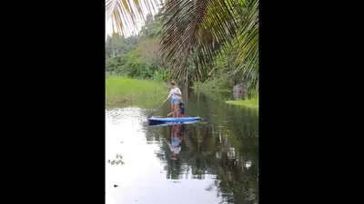 a man on a paddle board in the water at Method Living Tropical Edition in Cabarete
