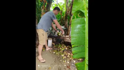 a man is standing next to a table with fruit at Method Living Tropical Edition in Cabarete