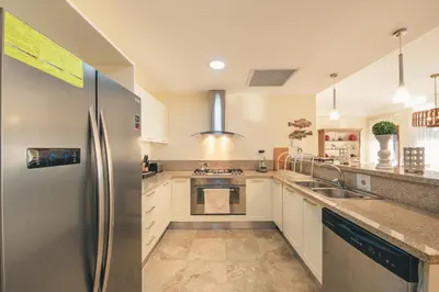 a kitchen with a stainless steel refrigerator at Luxurious Villa at Puerto Bahia with Great Views in Los Grini