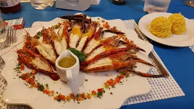 a plate of shrimp with dipping sauce on a table at Las Puertas del Paraíso in Río San Juan