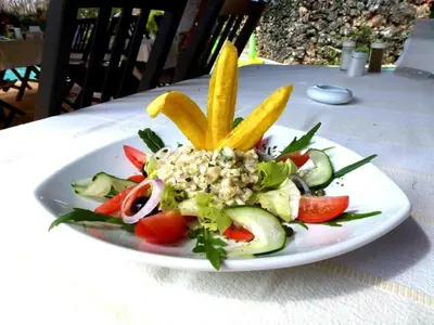 a plate of food with vegetables on a table at Las Puertas del Paraíso in Río San Juan