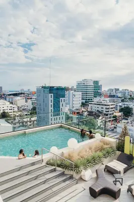a swimming pool on the roof of a building at Regatta Living Hotel By Mint in Santo Domingo