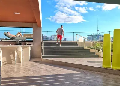 a man walking up the stairs of a building at Regatta Living Hotel By Mint in Santo Domingo