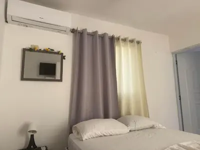 a bedroom with a bed and a window with curtains at Hotel Sol Azul in La Romana