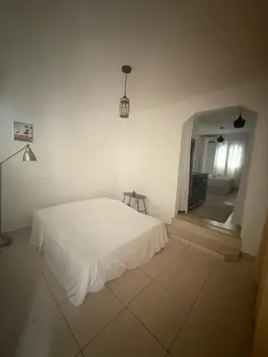 a bedroom with a white bed and a mirror at Hotel Sol Azul in La Romana