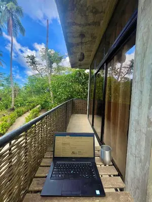 a laptop sitting on the porch of a house at Taino Beach Lofts in El Valle