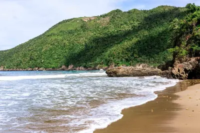 a view of the beach with a mountain in the background at Taino Beach Lofts in El Valle