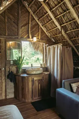 a bathroom with a sink in a log cabin at Bungalows India, El Valle, Samana in Santa Bárbara de Samaná