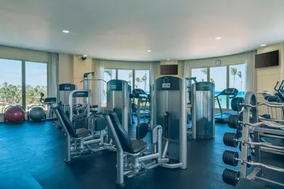 a gym with treadmills and machines in a room at JOIA Bavaro by Iberostar - Adults Only All Inclusive Resort in Punta Cana