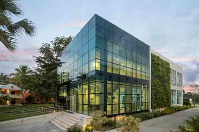 a glass office building with stairs in front of it at Iberostar Waves Punta Cana - All Inclusive in Punta Cana