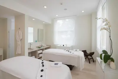 a hospital room with two beds and a mirror at Iberostar Waves Dominicana - All Inclusive in Punta Cana