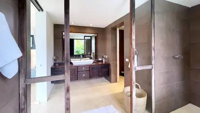 a bathroom with a shower and a sink at Villa Isha - modernist hideaway at Cap Bonita in Las Terrenas