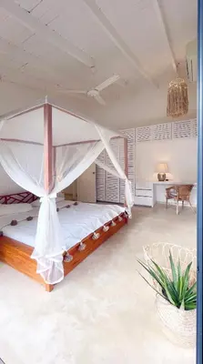 a bedroom with a bed with a canopy at Villa Isha - modernist hideaway at Cap Bonita in Las Terrenas