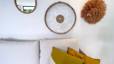 a room with pillows and mirrors on a wall at Villa Isha - modernist hideaway at Cap Bonita in Las Terrenas