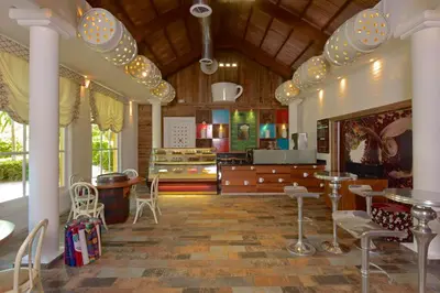 a living room with chairs and a dining room at Iberostar Selection Bavaro Suites - All Inclusive in Punta Cana