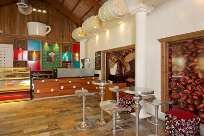 a store with stools and tables in a room at Iberostar Selection Bavaro Suites - All Inclusive in Punta Cana