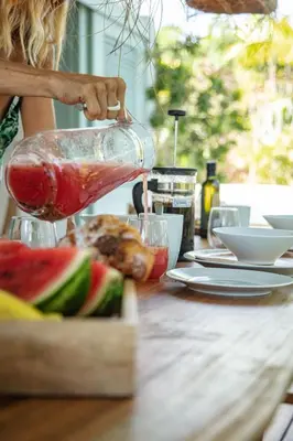a woman is preparing food on a table at Tropical Penthouse in the Heart of Las Terrenas! in Las Terrenas