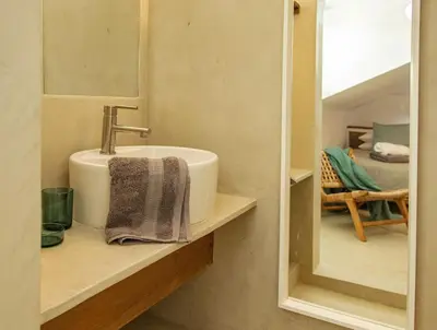 a bathroom with a sink and a mirror at Tropical Penthouse in the Heart of Las Terrenas! in Las Terrenas