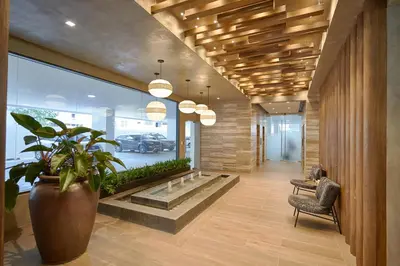 a hallway with a potted plant in a building at Monaco Residences Piantini in Santo Domingo