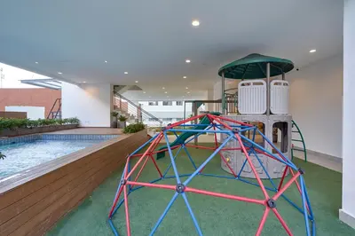a water slide in a building with a pool at Monaco Residences Piantini in Santo Domingo