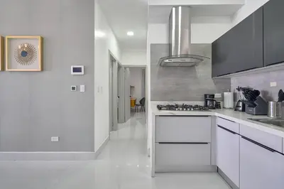 a kitchen with white counters and a stove top oven at Monaco Residences Piantini in Santo Domingo