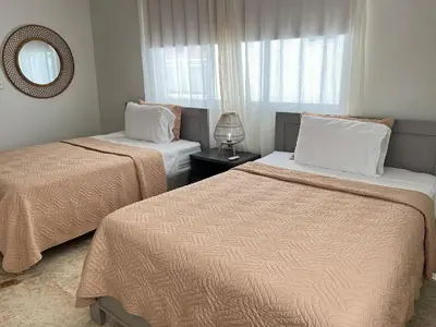a bedroom with two beds and a mirror and a window at Beach Residence | Escapada Penthouse Vista Mar in Punta Cana
