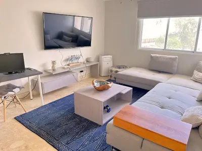 a living room with a couch and a flat screen tv at Beach Residence | Escapada Penthouse Vista Mar in Punta Cana